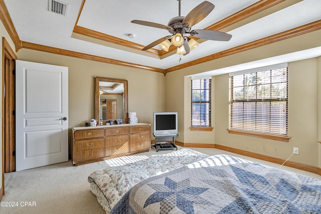 carpeted bedroom with ceiling fan, a textured ceiling, and ornamental molding