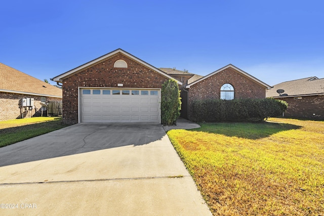 view of front of property with a garage and a front lawn