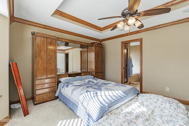 bedroom with ceiling fan, ornamental molding, light carpet, and connected bathroom