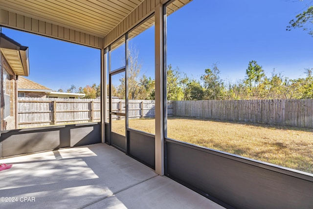 unfurnished sunroom featuring plenty of natural light and wooden ceiling