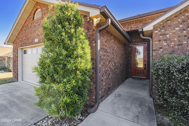 doorway to property featuring a garage