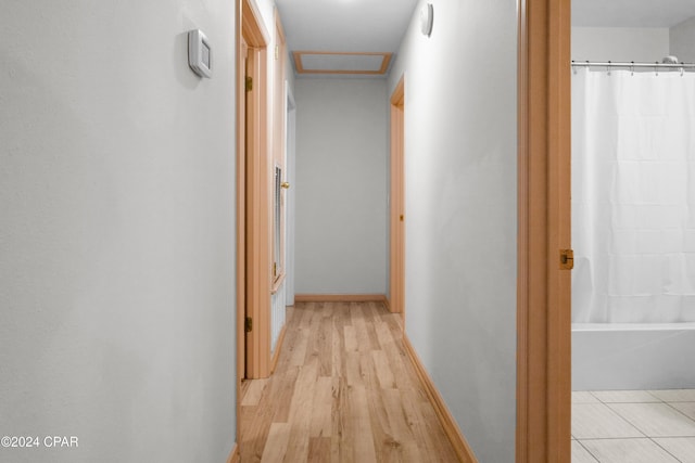 corridor with light wood-type flooring