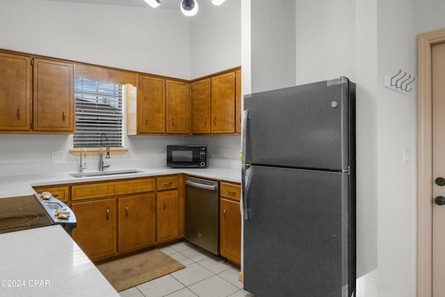 kitchen with light tile patterned floors, stainless steel appliances, and sink