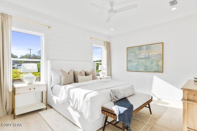 bedroom with light hardwood / wood-style floors and ceiling fan