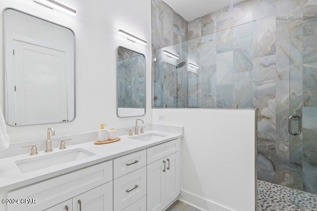 bathroom featuring vanity and a shower with shower door