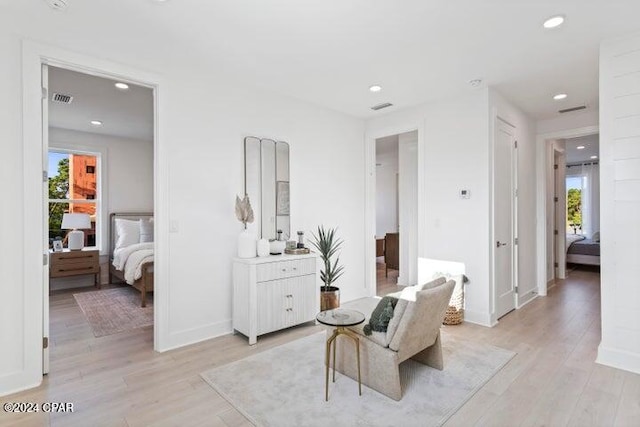 sitting room featuring plenty of natural light and light hardwood / wood-style flooring