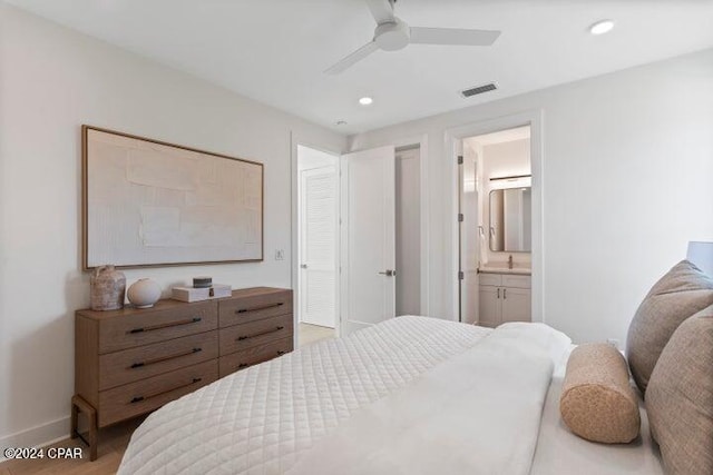 bedroom featuring light hardwood / wood-style flooring, ensuite bath, and ceiling fan