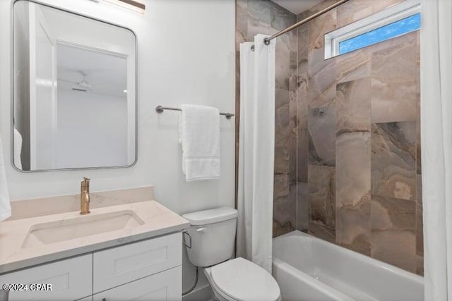 full bathroom featuring shower / bath combo with shower curtain, vanity, and toilet