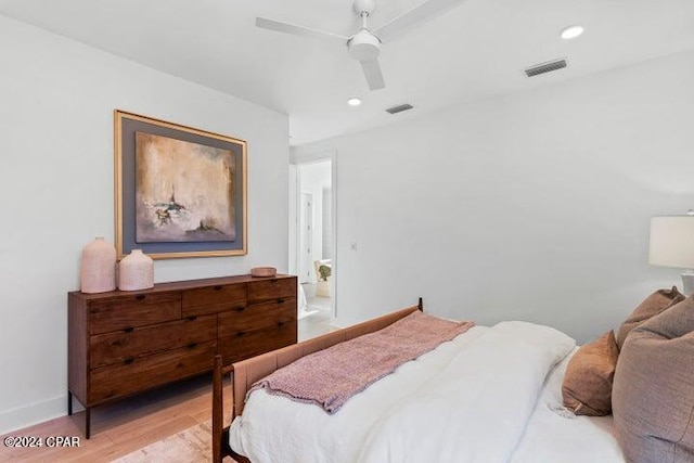 bedroom with light hardwood / wood-style floors and ceiling fan