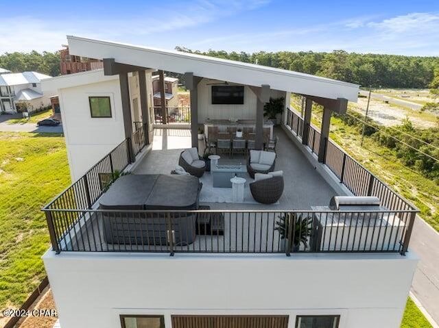 back of property featuring outdoor lounge area and a balcony