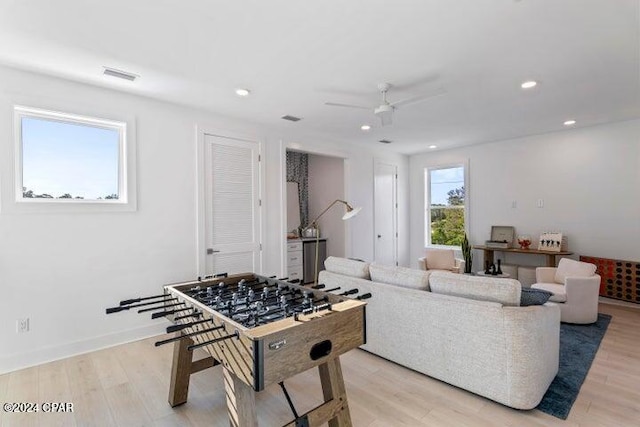 playroom with light hardwood / wood-style floors and ceiling fan