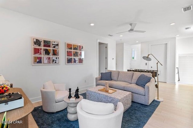 living room with hardwood / wood-style floors and ceiling fan