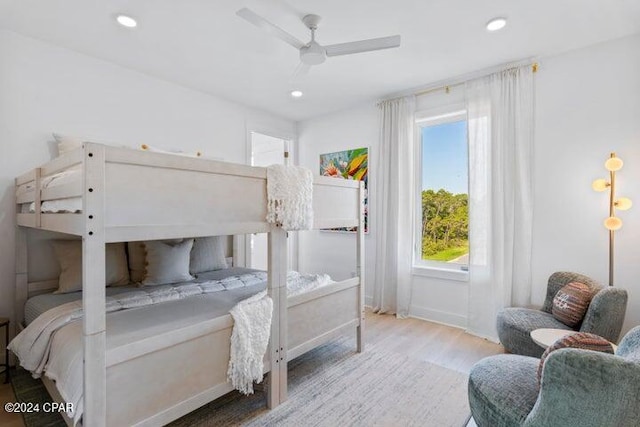 bedroom with ceiling fan and light hardwood / wood-style flooring