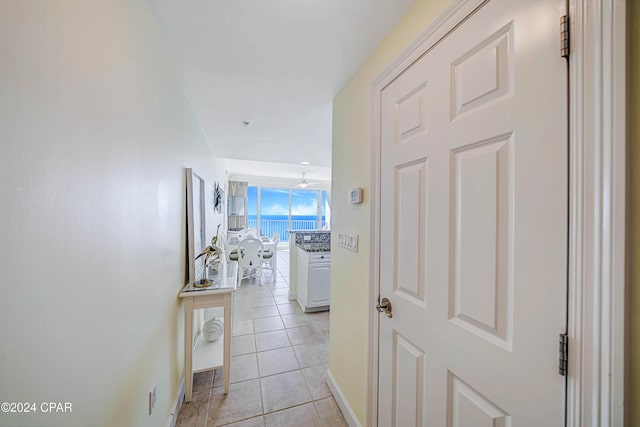 hall with light tile patterned floors