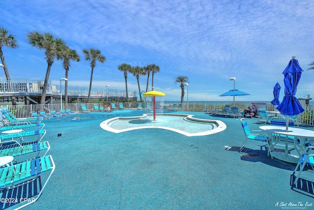 view of swimming pool with pool water feature