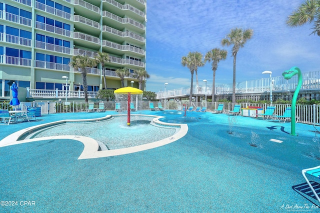 view of swimming pool with pool water feature