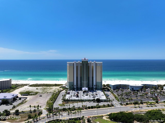 birds eye view of property with a water view and a beach view