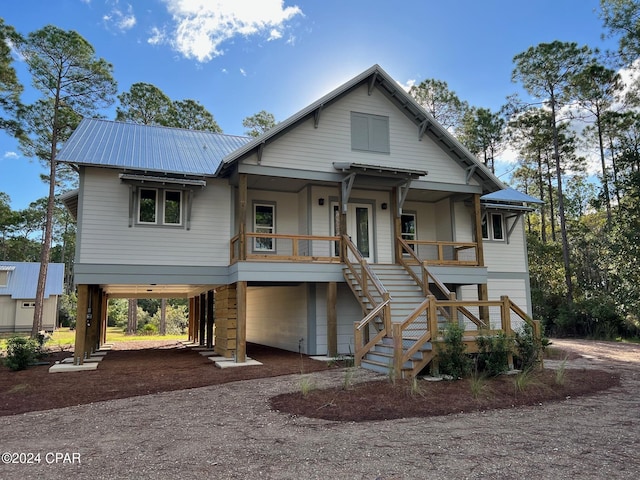 view of front of home featuring covered porch and a carport