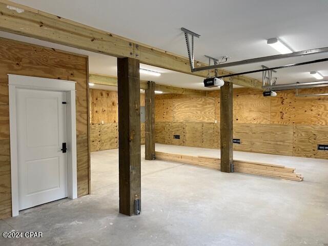 basement featuring wooden walls