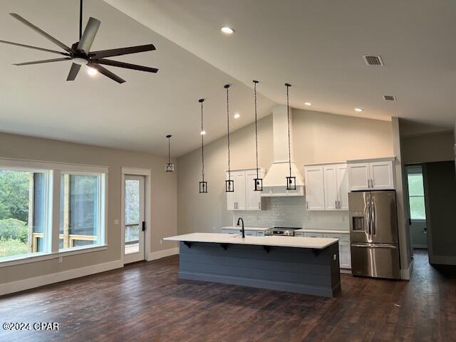 kitchen with pendant lighting, dark wood-type flooring, a spacious island, ceiling fan, and stainless steel appliances