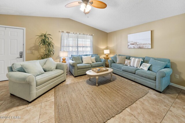 living room featuring light tile patterned floors, a textured ceiling, ceiling fan, and lofted ceiling