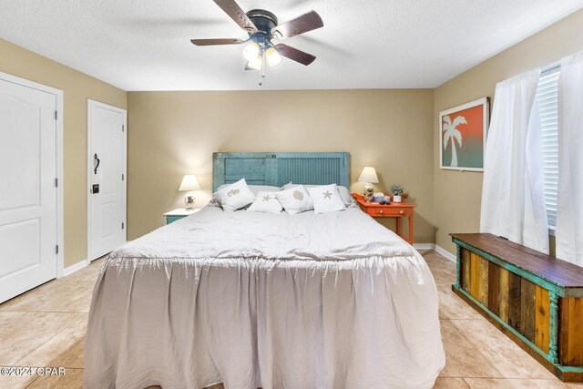 tiled living room featuring ceiling fan, a textured ceiling, and vaulted ceiling