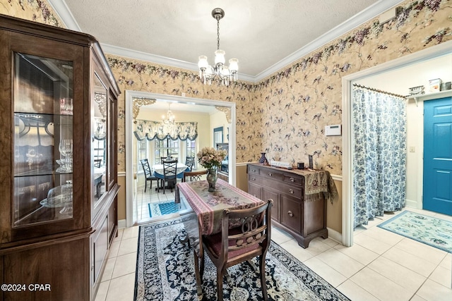 tiled dining area with a textured ceiling, an inviting chandelier, and ornamental molding