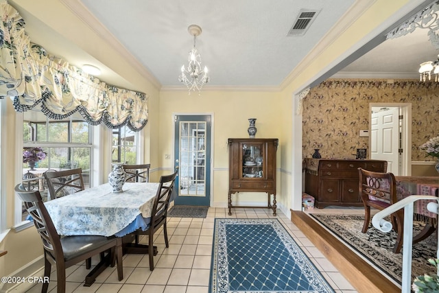 dining room featuring crown molding, light tile patterned floors, and an inviting chandelier