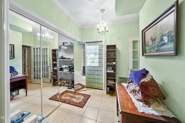 interior space featuring a notable chandelier, light tile patterned flooring, and ornamental molding