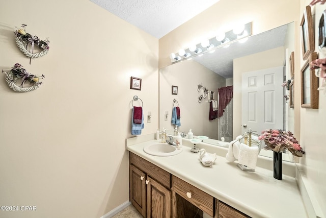 bathroom with vanity and a textured ceiling