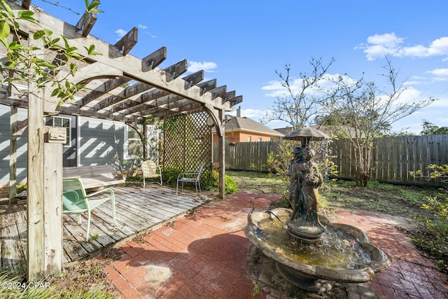 wooden deck with a pergola and a patio