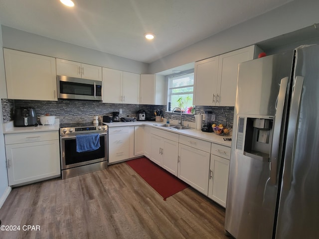 kitchen with dark hardwood / wood-style flooring, sink, white cabinetry, and stainless steel appliances