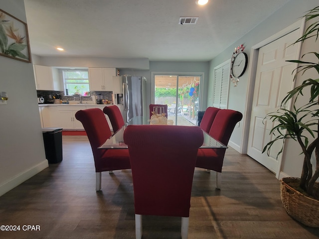 dining space featuring dark hardwood / wood-style flooring and sink