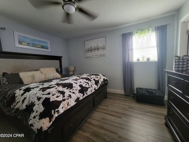 bedroom with ceiling fan and dark hardwood / wood-style flooring