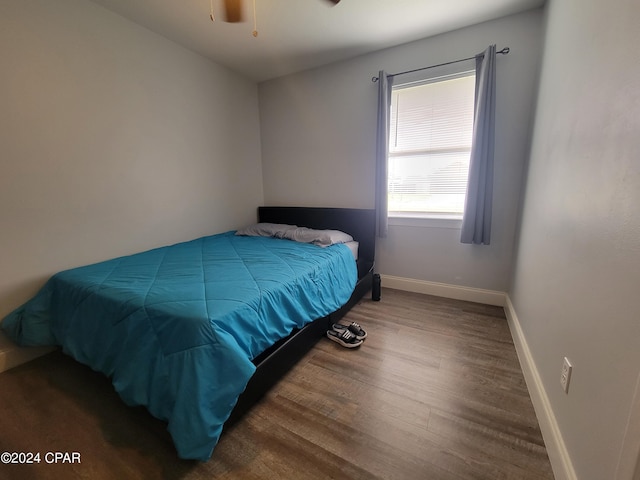 bedroom with ceiling fan and hardwood / wood-style floors