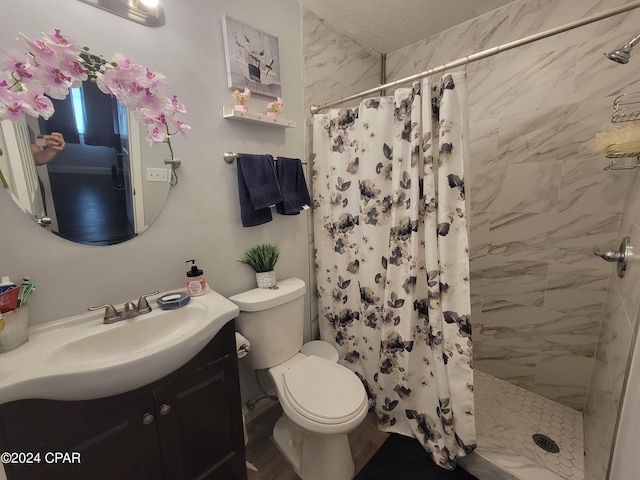 bathroom featuring vanity, toilet, and walk in shower