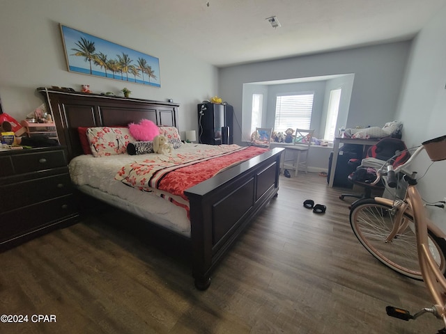 bedroom with dark wood-type flooring