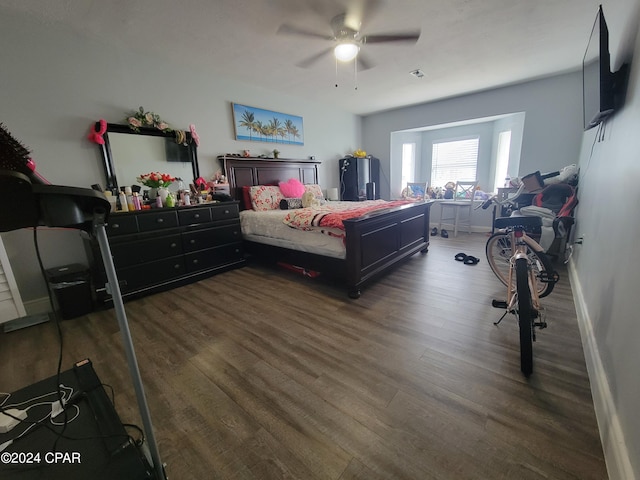 bedroom with ceiling fan and dark wood-type flooring