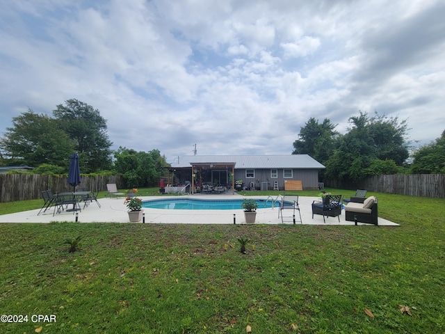 view of swimming pool with a yard, a patio, and an outdoor fire pit