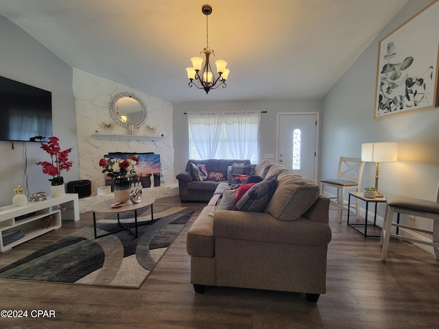 living room featuring a stone fireplace, dark wood-type flooring, a chandelier, and lofted ceiling