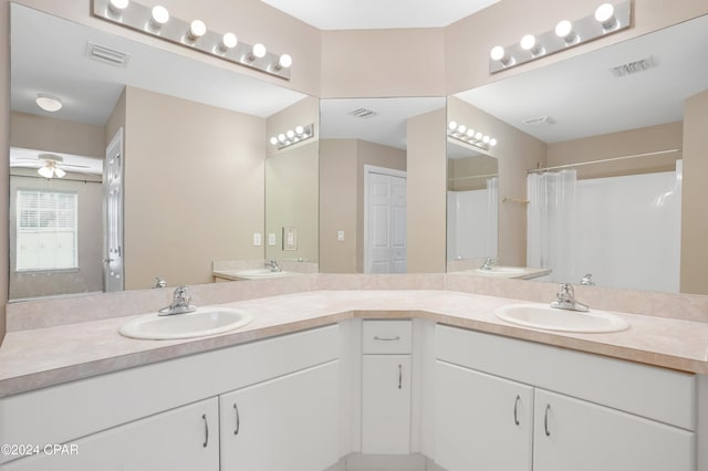 bathroom featuring vanity, ceiling fan, and curtained shower