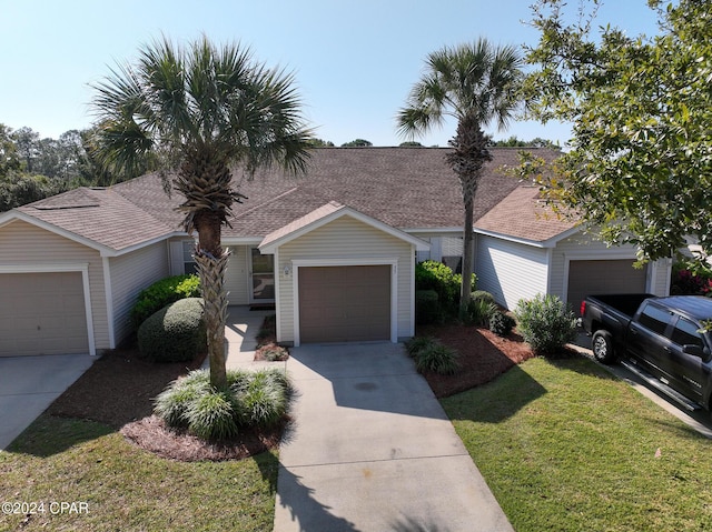 ranch-style house with a front yard and a garage