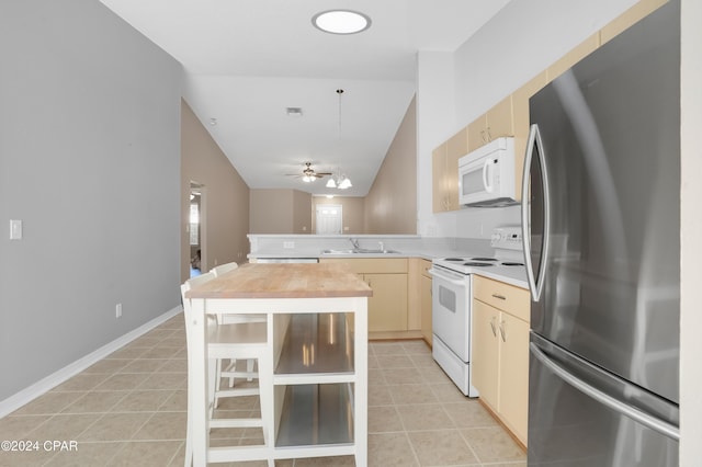 kitchen featuring light brown cabinets, white appliances, sink, ceiling fan, and kitchen peninsula