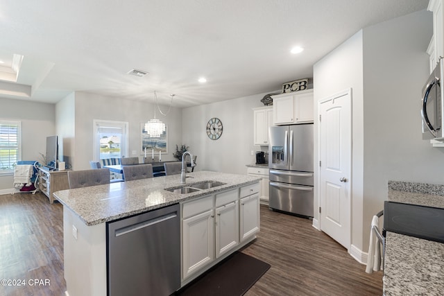 kitchen with white cabinetry, sink, dark hardwood / wood-style floors, an island with sink, and appliances with stainless steel finishes