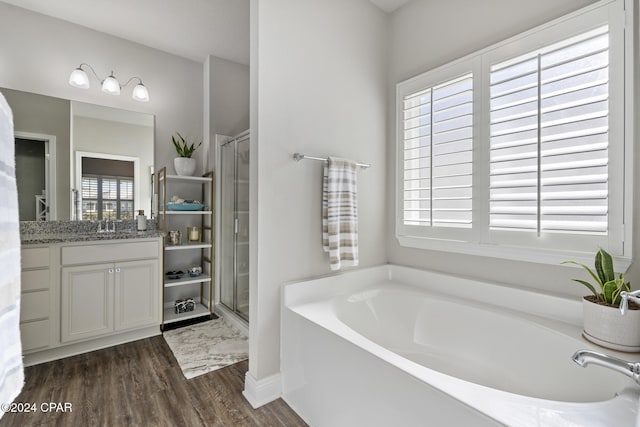 bathroom with separate shower and tub, vanity, a healthy amount of sunlight, and hardwood / wood-style flooring