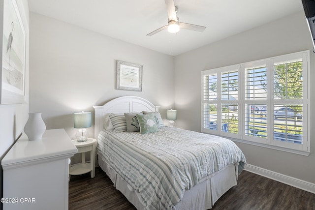 bedroom with dark hardwood / wood-style flooring and ceiling fan