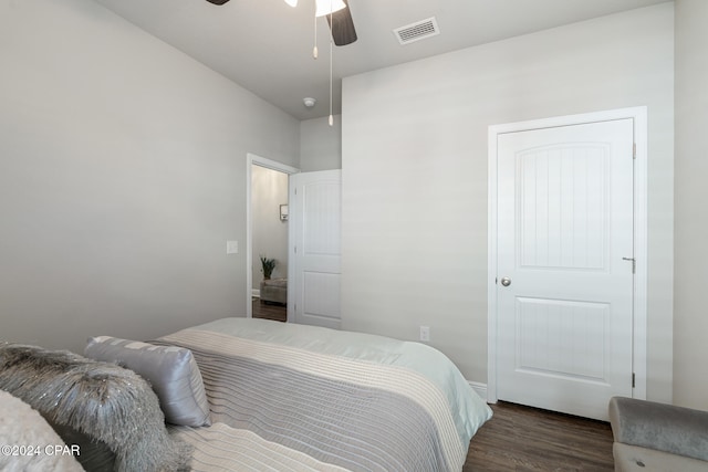 bedroom with ceiling fan and dark wood-type flooring