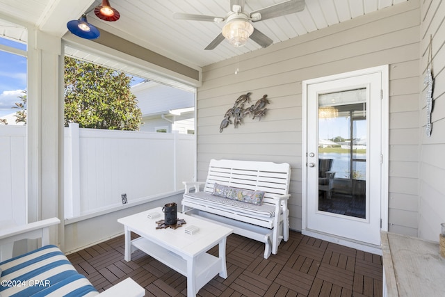 sunroom / solarium featuring ceiling fan