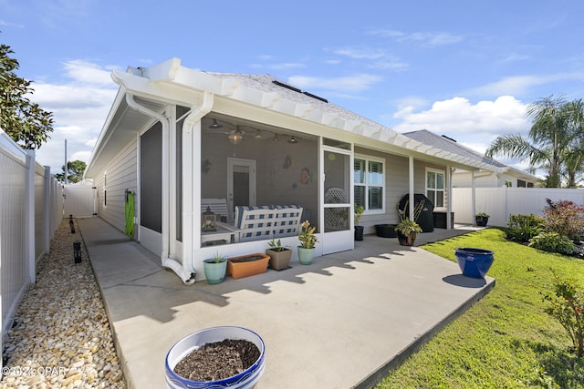 back of house with a sunroom, ceiling fan, and a patio area