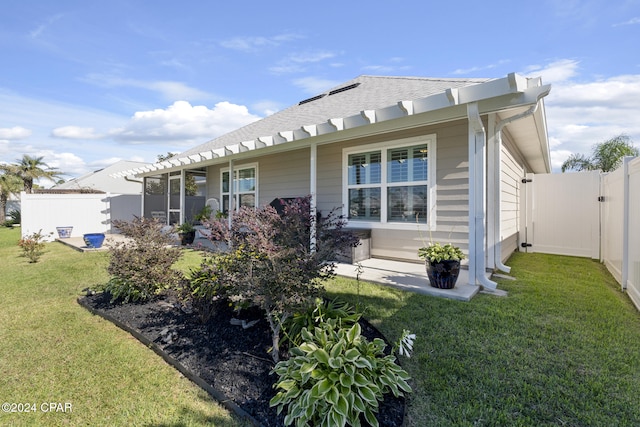 rear view of house featuring a lawn